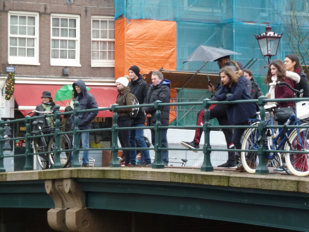 Locals and tourists watching the canals getting cleaned.